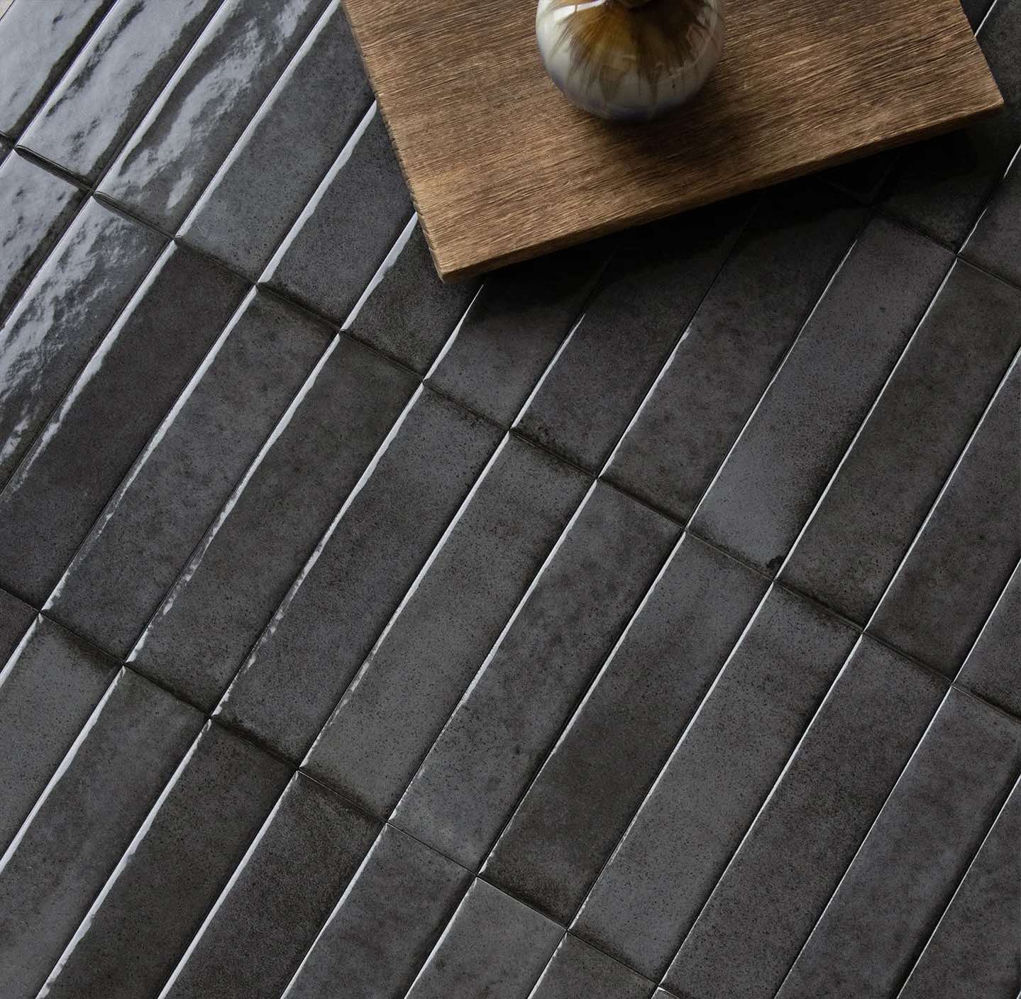 Dark gray tiles with a wooden coaster on top