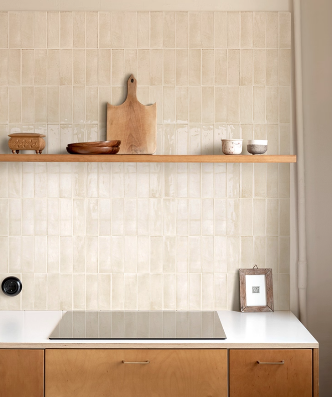 Modern kitchen with tiled wall, wooden shelves, and cabinets.