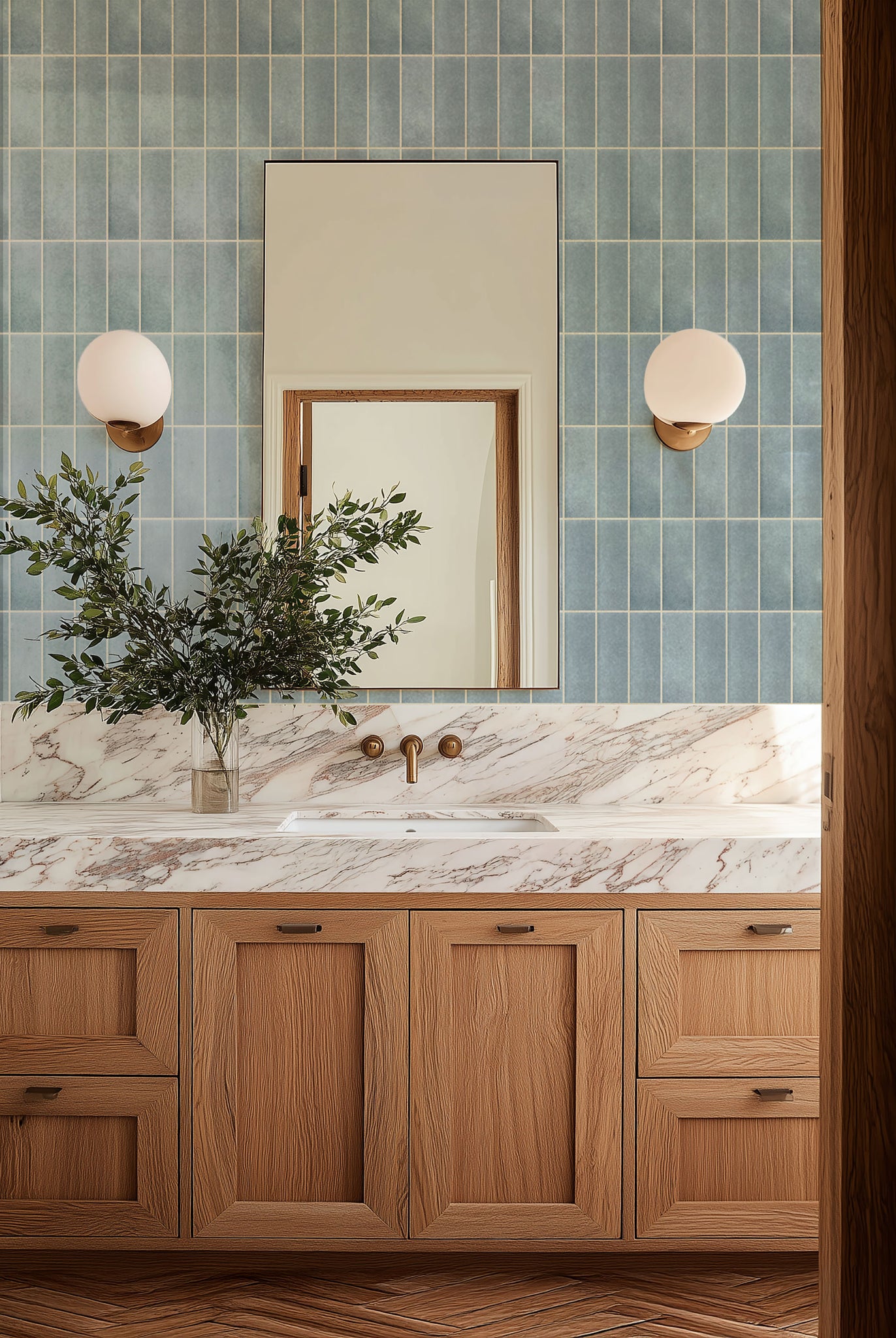 Bathroom with marble countertop, wooden cabinets, and blue tiled wall.